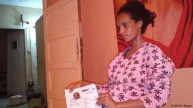 Eritrean refugee in Egypt holding her papers